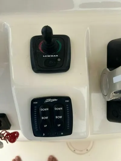  Yacht Photos Pics Close-up of 2019 Grady-White 306 CANYON boat controls, featuring Lewmar joystick and trim tab switches.
