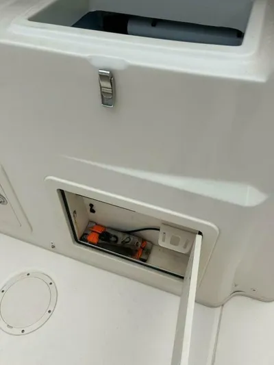  Yacht Photos Pics 2019 Grady-White 306 CANYON boat storage compartment with latch and interior view.