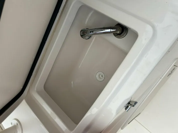  Yacht Photos Pics 2019 Grady-White 306 CANYON boat sink with faucet and storage compartment.