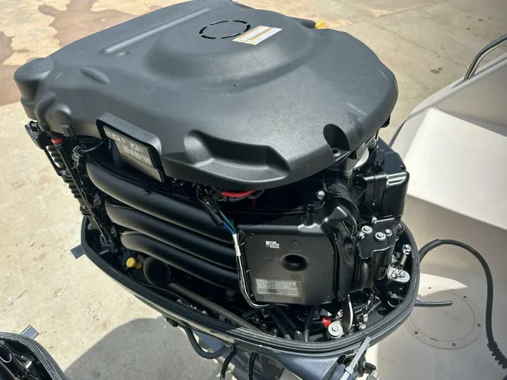  Yacht Photos Pics Close-up of a 2019 Grady-White 306 CANYON boat engine, showcasing intricate mechanical details.