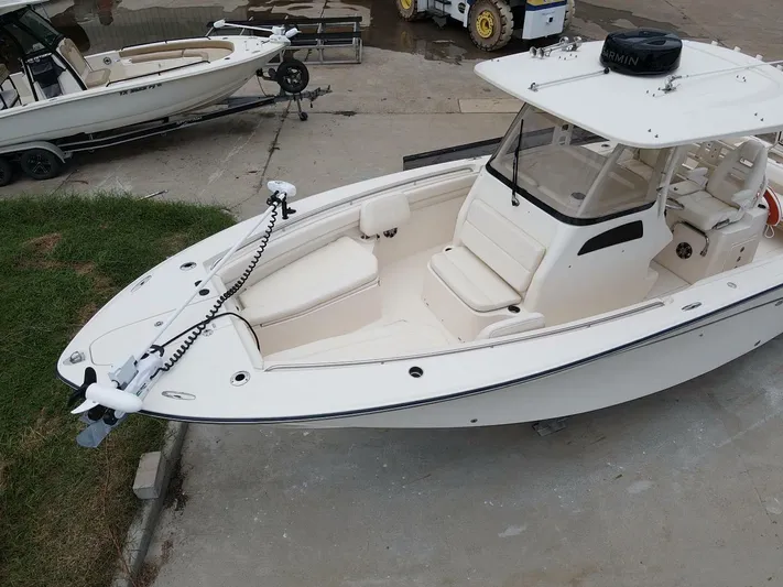  Yacht Photos Pics 2019 Grady-White 306 CANYON boat with white exterior, docked on concrete.