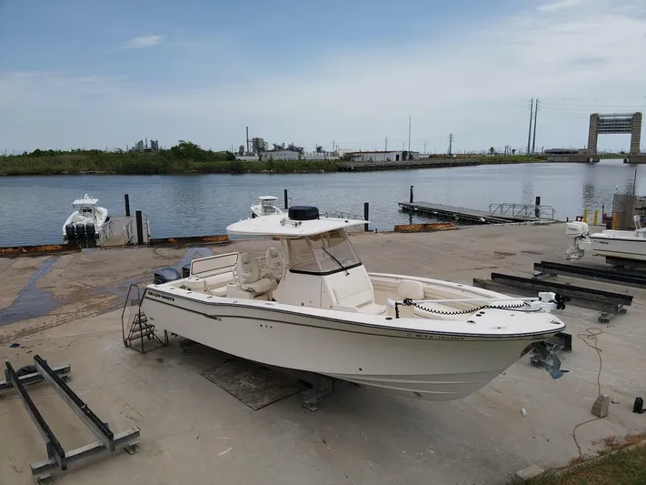  Yacht Photos Pics 2019 Grady-White 306 CANYON boat docked by a serene waterfront.
