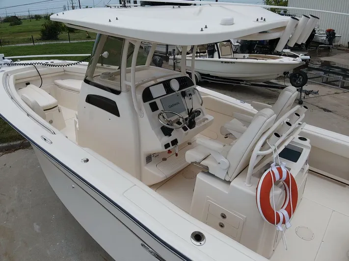  Yacht Photos Pics 2019 Grady-White 306 CANYON boat with helm, seating, and life preserver.