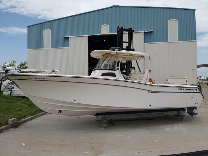 Yacht Photos Pics 2019 Grady-White 306 CANYON boat outside a large blue and white building.