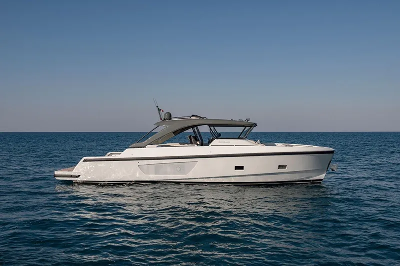 Bluegame Bg54#29 (new) Yacht Photos Pics 2025 Bluegame BG54 yacht cruising on open sea under clear blue sky.