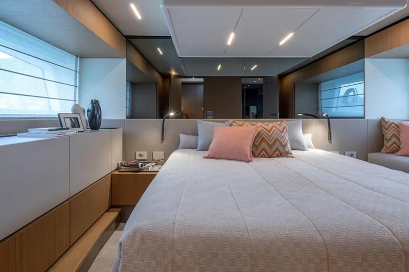 Bluegame Bg54#29 (new) Yacht Photos Pics Luxurious bedroom interior of 2025 Bluegame BG54 yacht with modern design and cozy bedding.