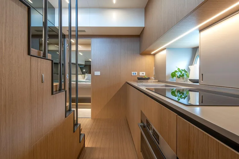 Bluegame Bg54#29 (new) Yacht Photos Pics Modern interior of 2025 Bluegame BG54 yacht with sleek kitchen design and wooden finishes.