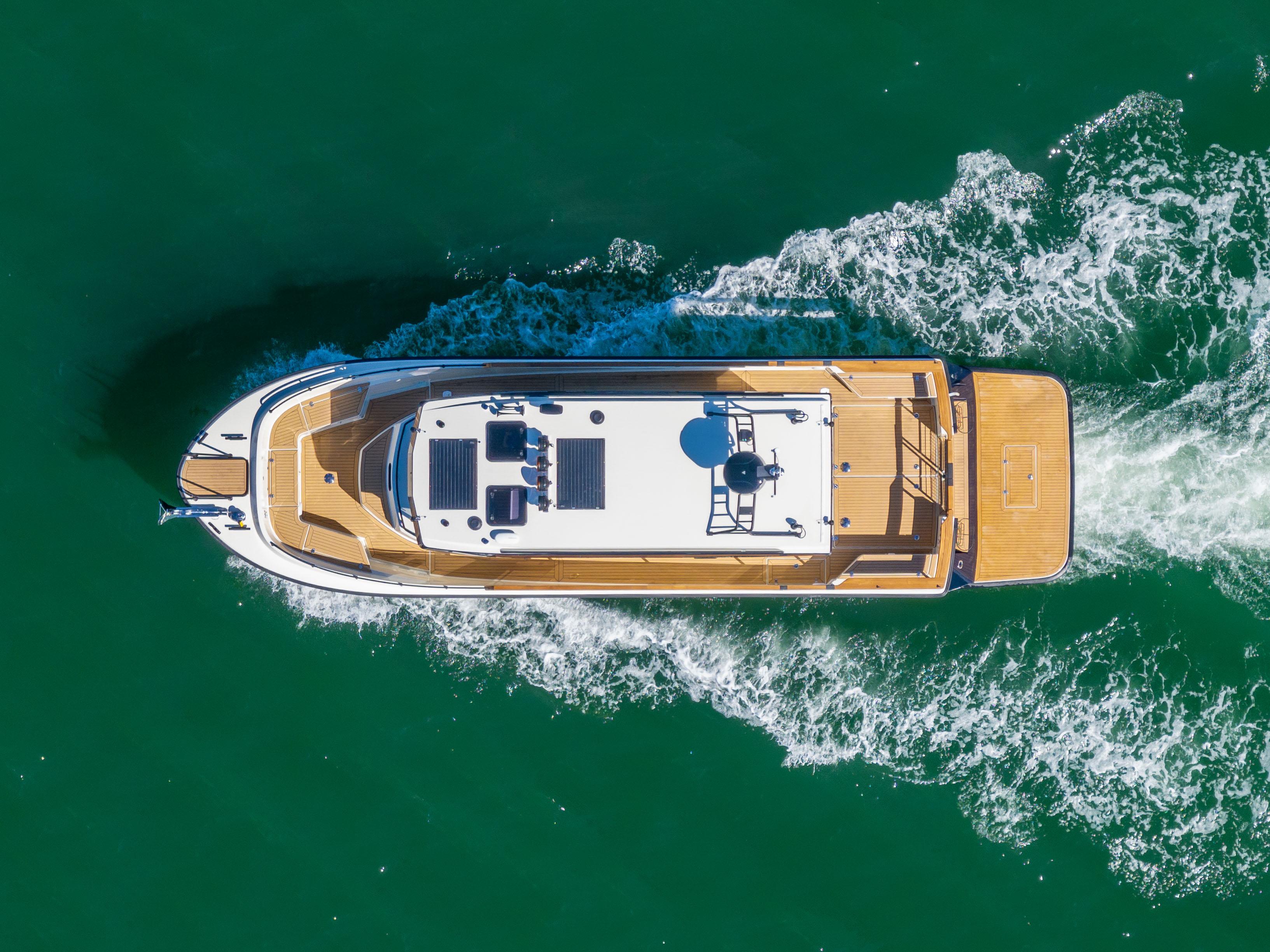 Aerial view of 2025 Targa 37 yacht cruising on green water.