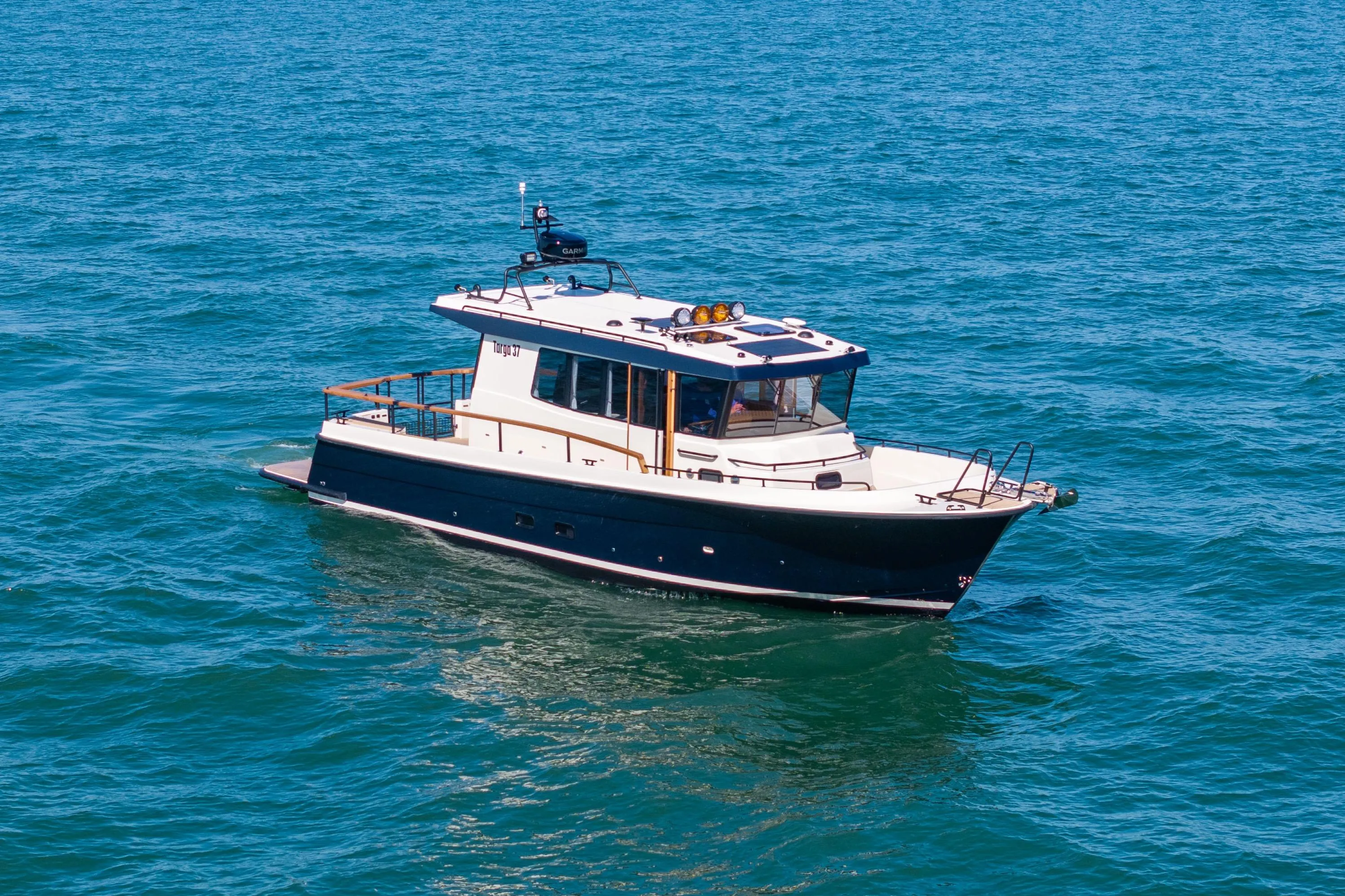 2025 Targa 37 boat cruising on open blue water.