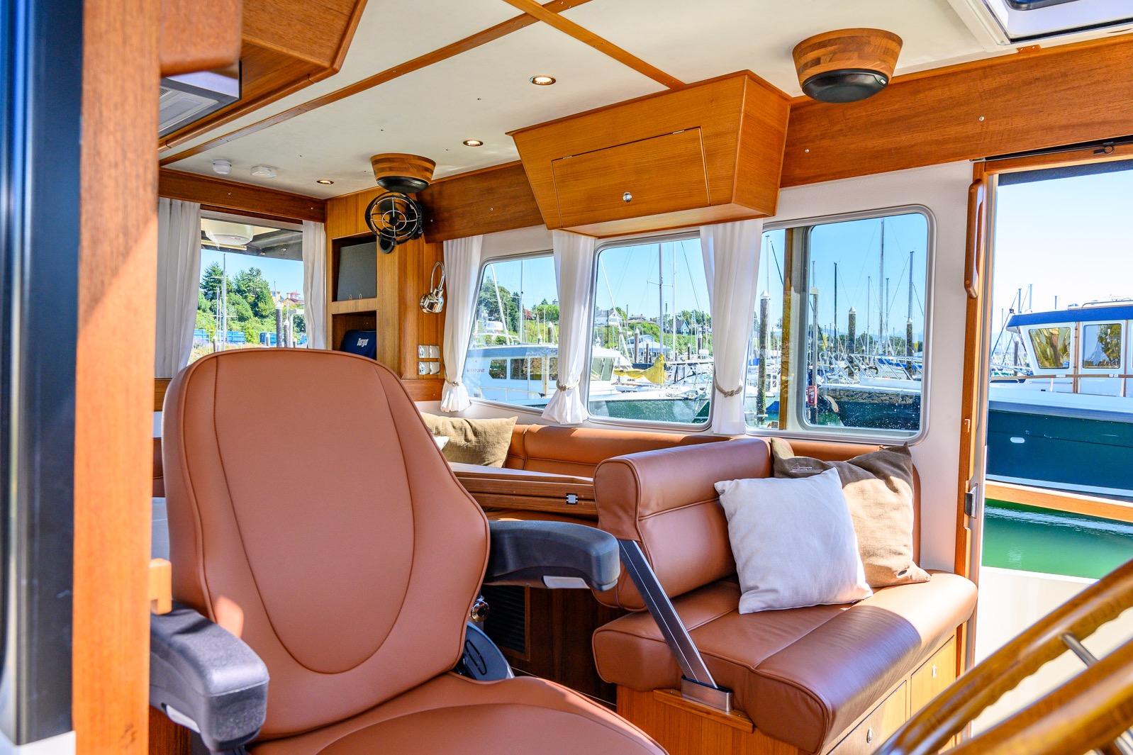 Luxurious interior of 2025 Targa 37 boat with leather seating and marina view.