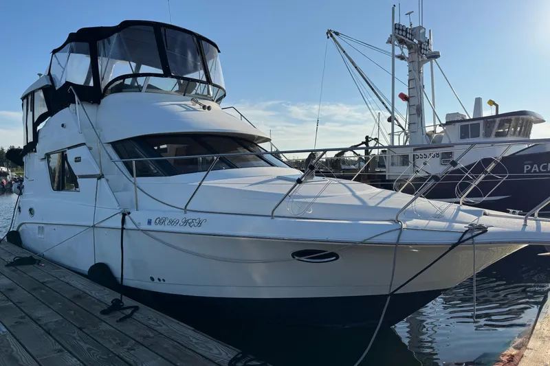  Yacht Photos Pics 2002 Silverton 352 Motor Yacht docked at marina, clear sky background.