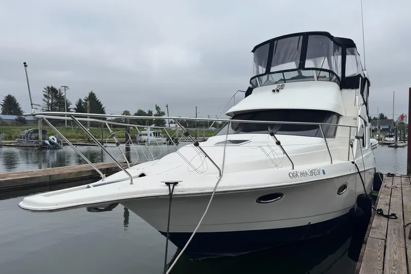  Yacht Photos Pics 2002 Silverton 352 Motor Yacht docked at a marina, overcast sky.