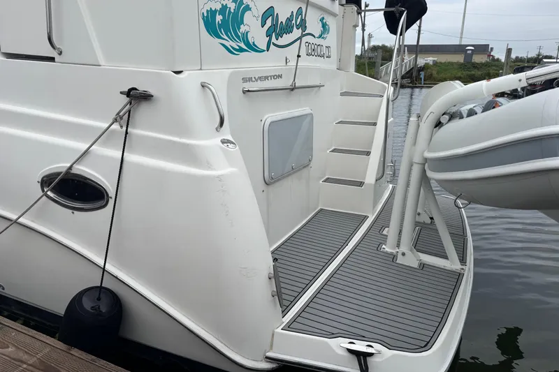  Yacht Photos Pics 2002 Silverton 352 Motor Yacht docked with inflatable boat attached.