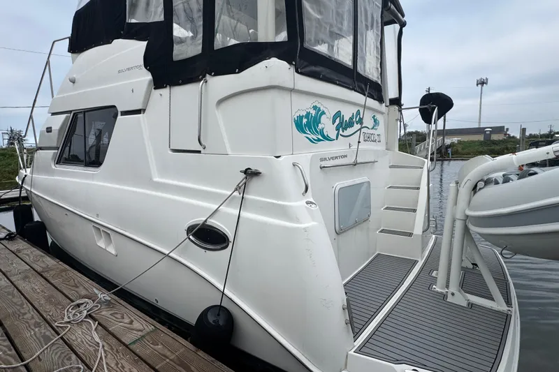  Yacht Photos Pics 2002 Silverton 352 Motor Yacht docked, featuring sleek design and spacious deck area.