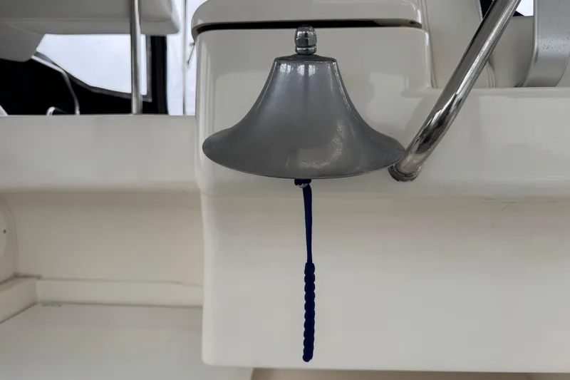  Yacht Photos Pics Silverton 352 Motor Yacht 2002 bell with blue rope pull on white background.