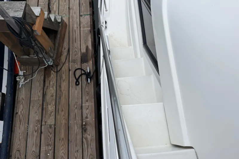  Yacht Photos Pics 2002 Silverton 352 Motor Yacht docked, showing side steps and wooden pier.