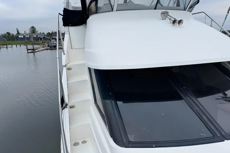  Yacht Photos Pics 2002 Silverton 352 Motor Yacht docked, showcasing sleek design and spacious deck area.