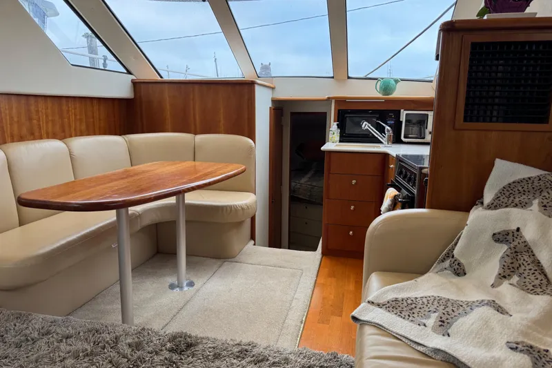  Yacht Photos Pics Interior of 2002 Silverton 352 Motor Yacht with cozy seating and kitchenette.