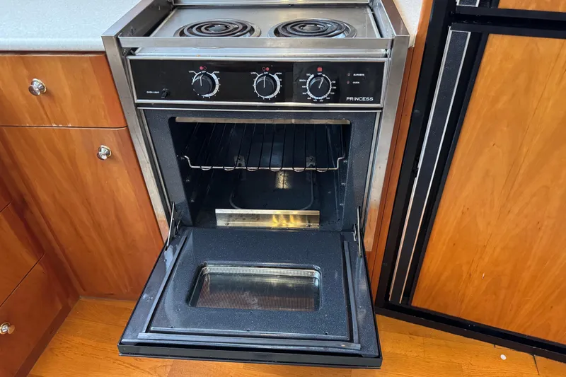  Yacht Photos Pics 2002 Silverton 352 Motor Yacht kitchen with open oven and stovetop.