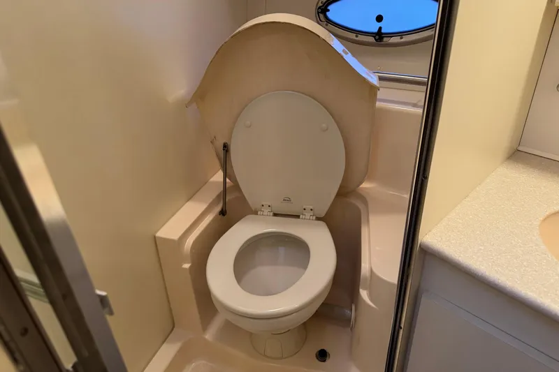  Yacht Photos Pics 2002 Silverton 352 Motor Yacht bathroom with toilet and porthole window.