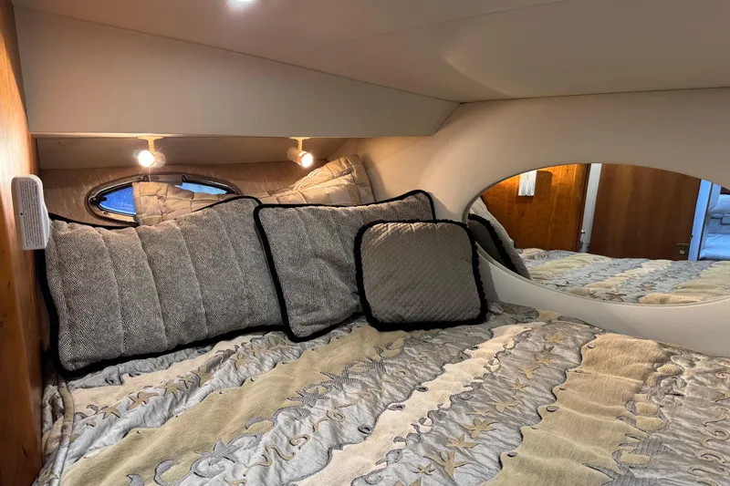  Yacht Photos Pics Cozy bedroom in 2002 Silverton 352 Motor Yacht with elegant bedding and soft lighting.