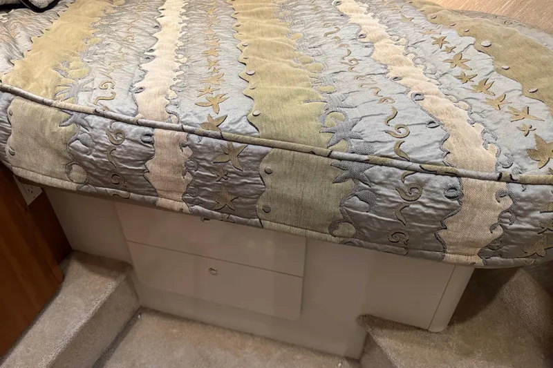  Yacht Photos Pics 2002 Silverton 352 Motor Yacht interior with patterned bedspread and storage drawers.