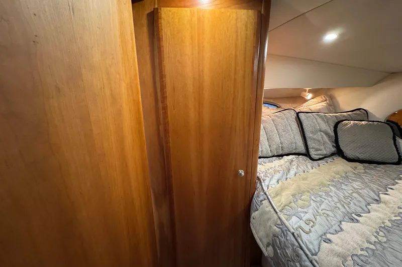  Yacht Photos Pics Interior of 2002 Silverton 352 Motor Yacht with cozy bed and wooden cabinetry.