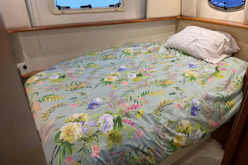  Yacht Photos Pics Cozy bedroom in 2002 Silverton 352 Motor Yacht with floral bedding and porthole window.