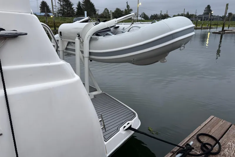  Yacht Photos Pics 2002 Silverton 352 Motor Yacht with dinghy on davit at dockside.