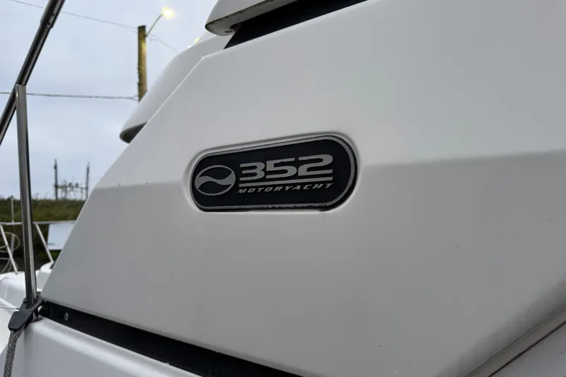  Yacht Photos Pics 2002 Silverton 352 Motor Yacht emblem on white exterior.