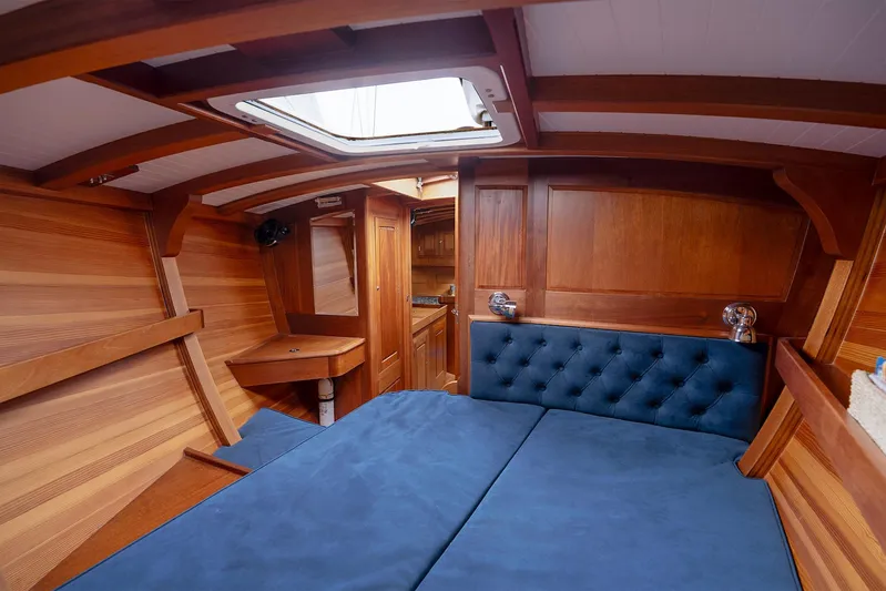  Yacht Photos Pics Luxurious wooden interior of 2011 Spirit 50 DH yacht with blue cushioned seating.