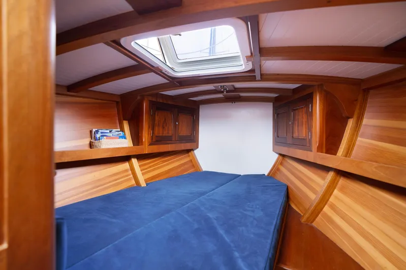  Yacht Photos Pics Luxurious wooden cabin interior of 2011 Spirit 50 DH yacht with blue bedding.