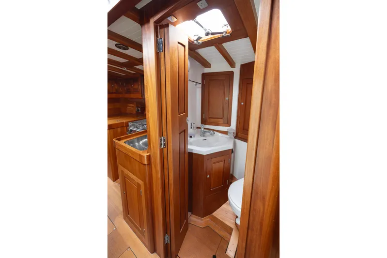  Yacht Photos Pics Interior of 2011 Spirit 50 DH yacht, featuring wooden cabinetry and compact bathroom.