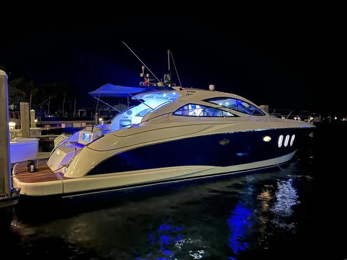 Astondoa 53 Open Yacht Photos Pics 2005 Astondoa 53 Open yacht illuminated at night, docked in a marina.