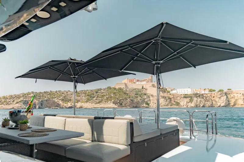 La Romana Yacht Photos Pics Luxury yacht deck with seating and umbrellas, Cantiere Arno Leopard 31, 2006 model, coastal view.