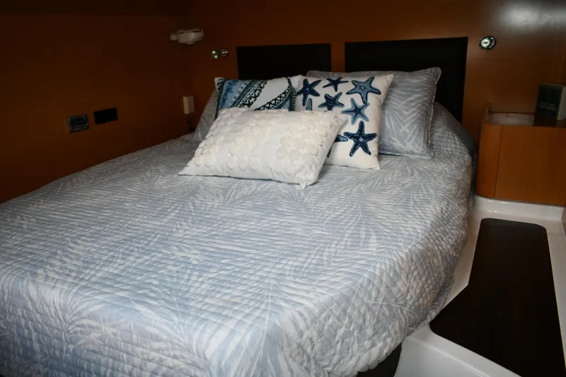 Beach Cat Yacht Photos Pics Cozy bedroom in 2012 Fountaine Pajot 40 yacht with starfish-themed pillows.