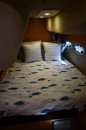 Beach Cat Yacht Photos Pics Cozy cabin interior of 2012 Fountaine Pajot 40 with patterned bedding and porthole windows.