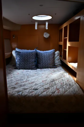 Beach Cat Yacht Photos Pics Cozy cabin interior of 2012 Fountaine Pajot 40 catamaran with bed and storage shelves.