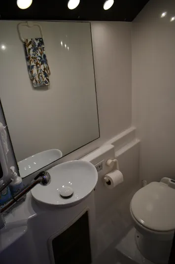 Beach Cat Yacht Photos Pics Bathroom interior of 2012 Fountaine Pajot 40 catamaran with sink, mirror, and toilet.