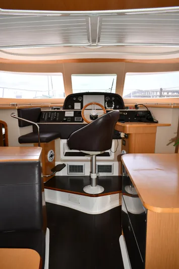 Beach Cat Yacht Photos Pics Interior of 2012 Fountaine Pajot 40 yacht, featuring helm station and seating area.