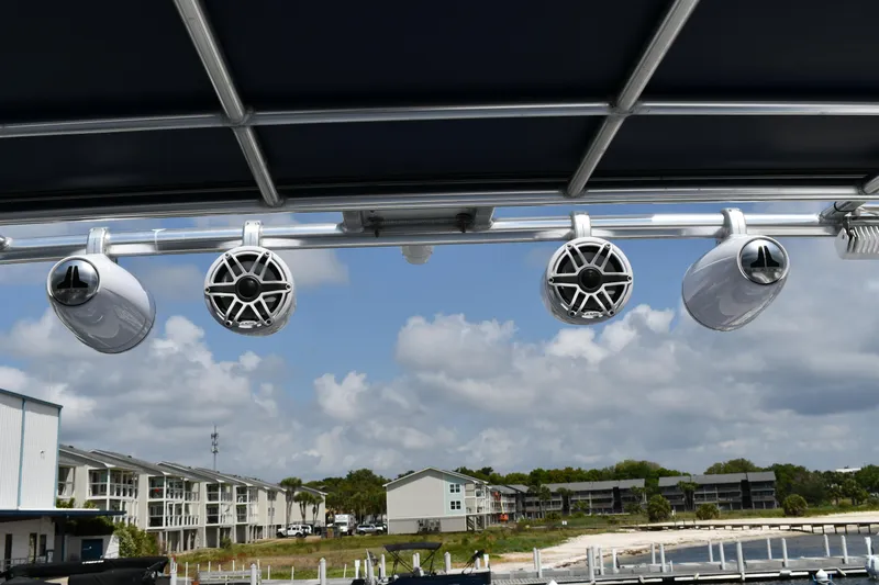 Beach Cat Yacht Photos Pics Rooftop speakers on a 2012 Fountaine Pajot 40 catamaran, with a scenic marina backdrop.