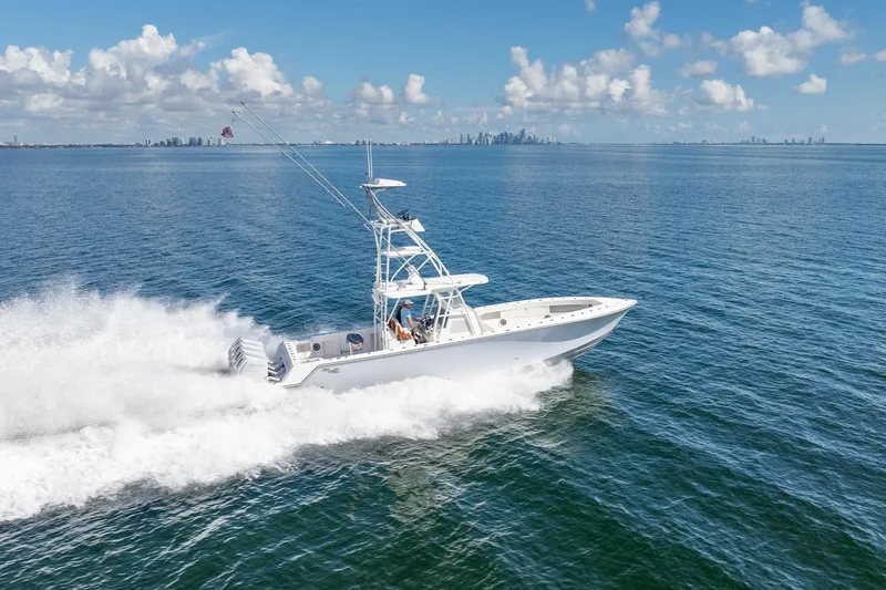  Yacht Photos Pics 2024 SeaVee 400Z boat cruising on open water under a clear blue sky.