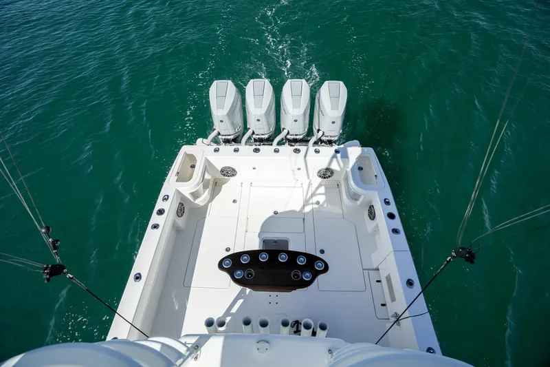  Yacht Photos Pics 2024 SeaVee 400Z boat with four powerful outboard engines on turquoise water.