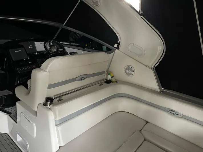  Yacht Photos Pics 2014 Rinker 360 Express Cruiser interior with white seating and helm controls.