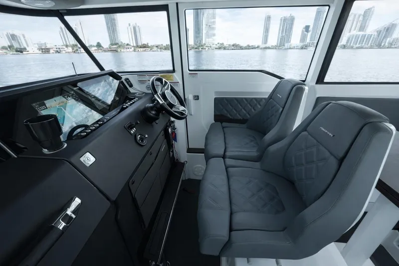  Yacht Photos Pics Interior of 2022 Axopar 37 XC Cross Cabin with modern dashboard and seating.