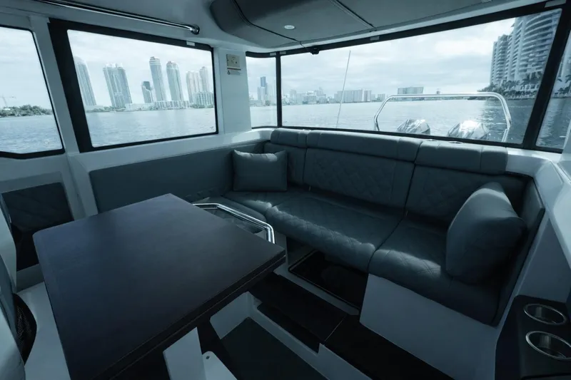 Yacht Photos Pics Interior of 2022 Axopar 37 XC Cross Cabin with cityscape view through windows.
