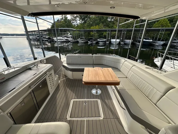  Yacht Photos Pics Luxurious 2022 Sea Ray SLX 400 yacht interior with elegant seating and wooden table.
