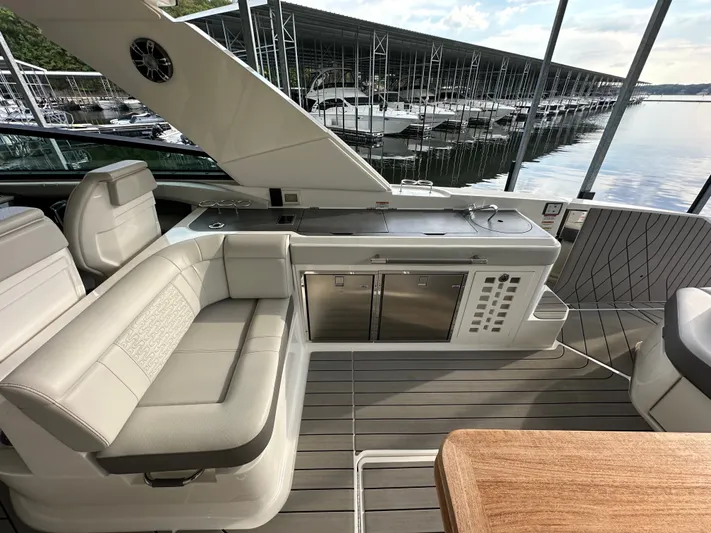  Yacht Photos Pics 2022 Sea Ray SLX 400 boat interior with seating and kitchenette, docked at marina.