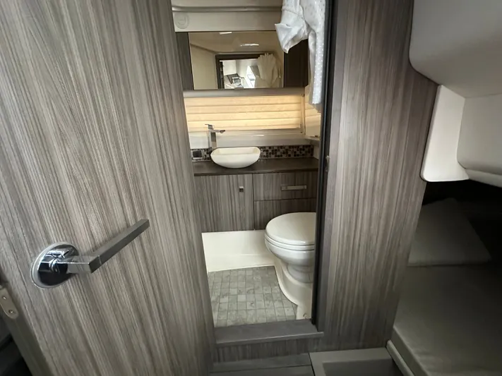  Yacht Photos Pics Luxurious bathroom interior of 2022 Sea Ray SLX 400 yacht, featuring modern fixtures and wood finish.