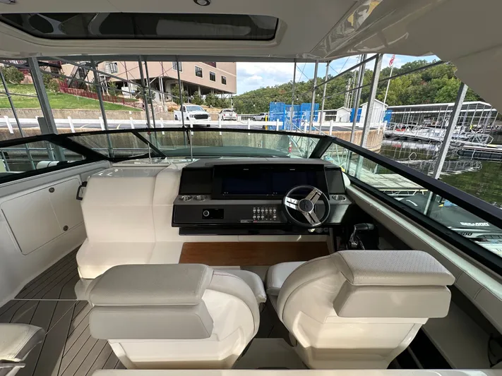  Yacht Photos Pics Interior view of 2022 Sea Ray SLX 400 boat cockpit with modern controls and seating.